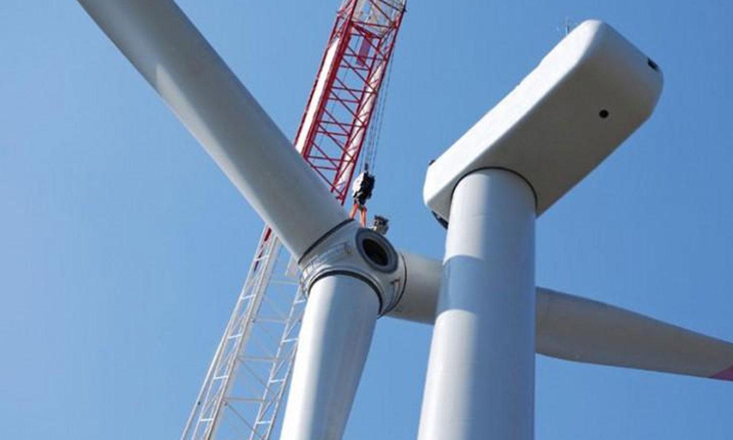 Wind turbine blades installed by a crane