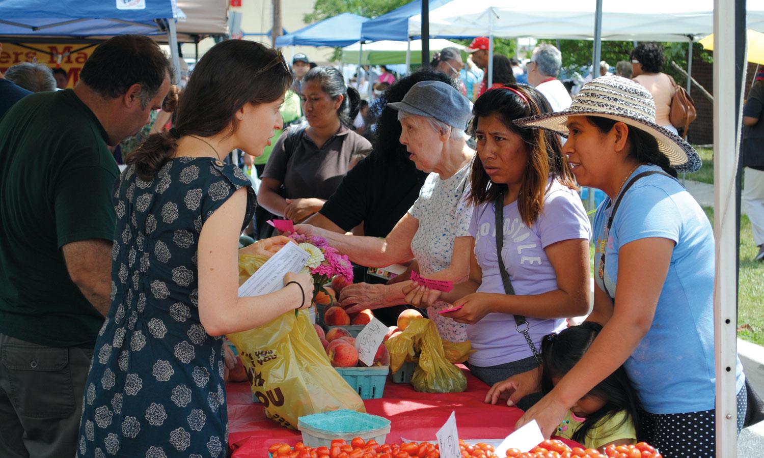 Women buying food at farmers market