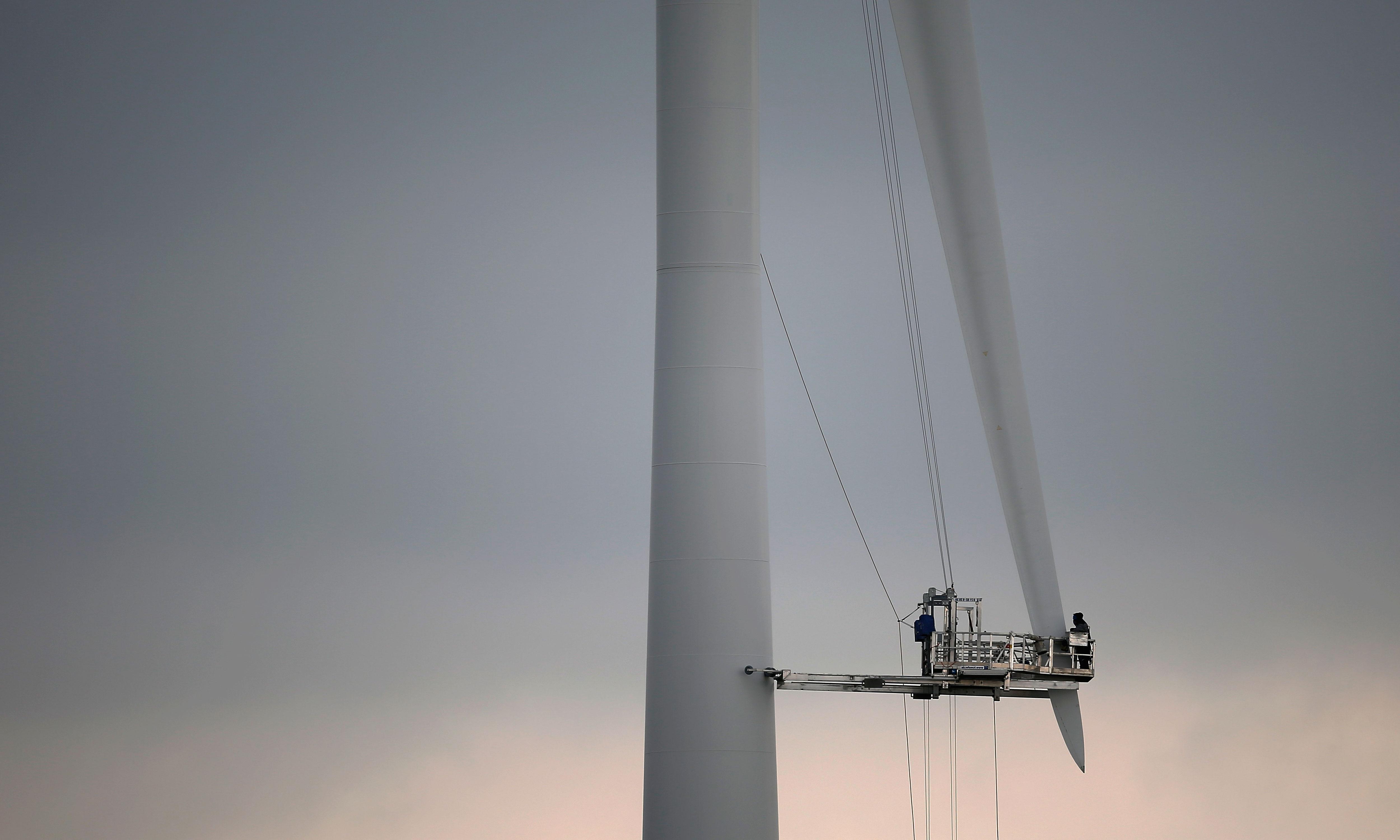 Workers on a ginormous wind turbine
