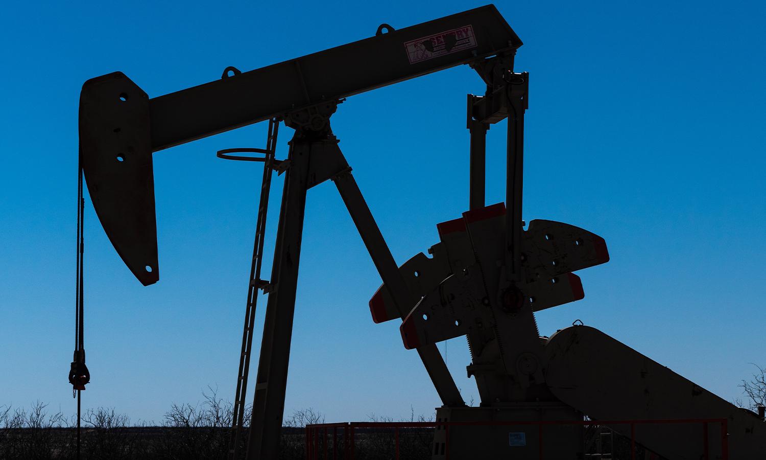 A silhouette of an oil pumpjack.