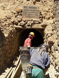 Two workers going into a mine