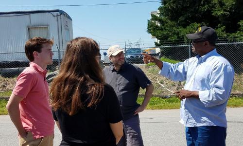 Community activist giving tour of hazardous site.