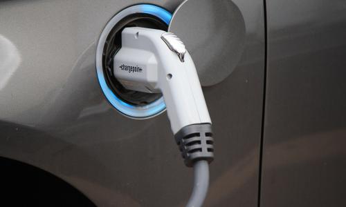 Grey electric vehicle at electric vehicle charging station