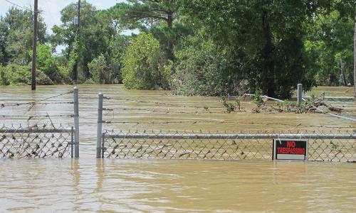 Gate to toxic waste site almost submerged by floodwaters