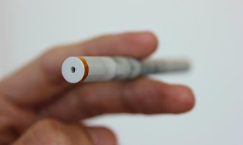 E-cigarette held between someone's fingers