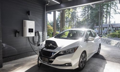 white electric vehicle charging in a residential garage